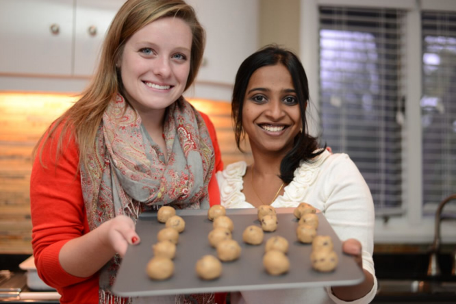 Student and volunteer holding cookies