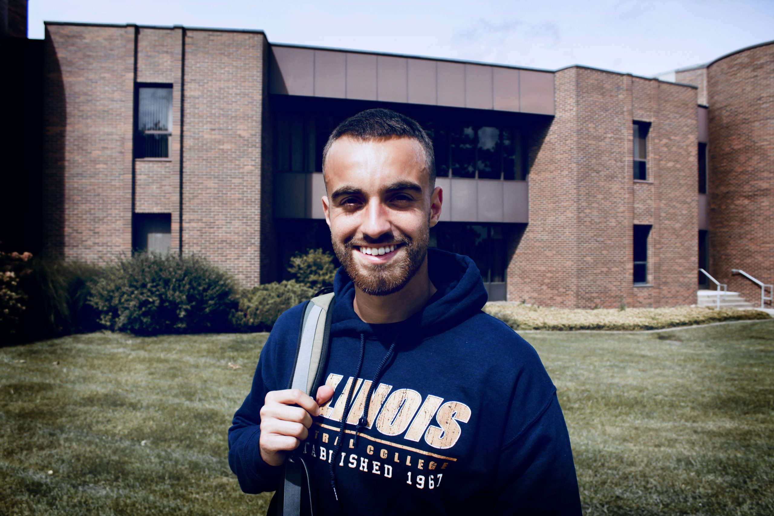 Student from Brazil holding backpack